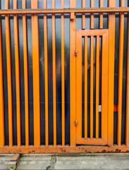 Fototapeta premium Tall Iron Gate of a Factory by the Roadside