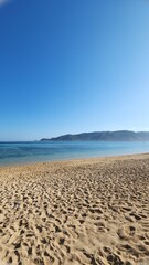 View of Kuta Mandalika beach, with clear blue sky and turquoise ocean, Lombok West Nusa Tenggara - Indonesia l in summer. This beach is famous for its pepper-shaped sand