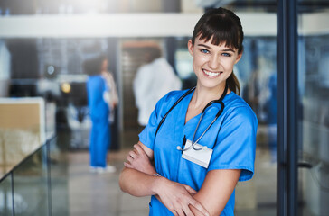 Portrait, happy woman or nurse with arms crossed in hospital for healthcare services, career or...