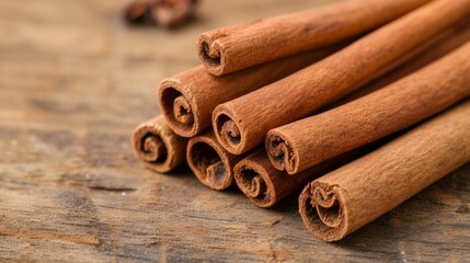 Aromatic cinnamon sticks placed on a rustic wooden surface