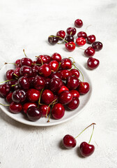 red cherry, cherry berry, scattered on a plate, top view, no people,