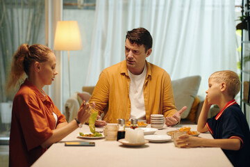 Family having an argument while having dinner with their son at home