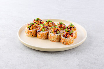 Beautiful Philadelphia Sushi Rolls Set with Salmon and Cream Cheese, Tobiko and Cuccumber on Black Slate Plate Close Up. Uramaki, Nori Maki or Futomaki Sushi with Trout Fillets