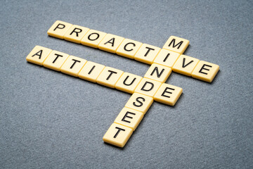 proactive mindset - crossword in ivory tiles against gray textured paper, business and personal development concept