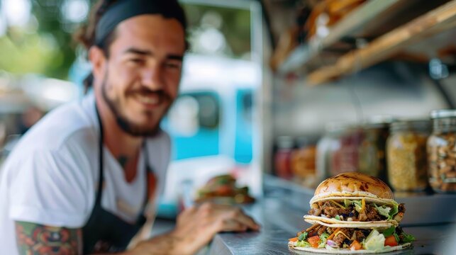 A smiling man at a food truck displaying a gourmet burger, as part of a casual dining experience, emphasizing quality, freshness, and modern street food culture.