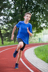 An athlete runs along a stadium bend.
