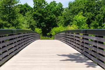 Pedestrian bridge over Charles River in Watertown with scenic green background, MA, USA