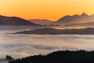Warm sunrise over the Aramaio Valley, Araba, covered by a sea of ​​low clouds