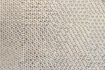 Detailed View of Metallic Circular Tiles Creating a Lustrous Surface Finish in Bathroom Shower