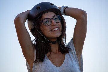 Female Skateboarder wearing helmet looking towards camera - horizontal