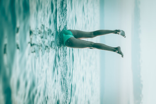 handstand under water and two legs over sea surface