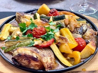 Close up fish casserole with fresh vegetables. 