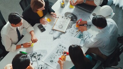 Top view of professional engineer showing and talking about turbine engine design. Aerial view of skilled designer or technician group explain about electronic generator construction. Alimentation.