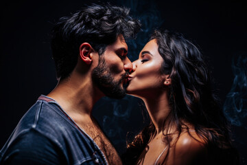 Young people in love. Close-up portrait of young couple in love, hug embrace with romance together, kissing, photographed in studio, dark background. 
