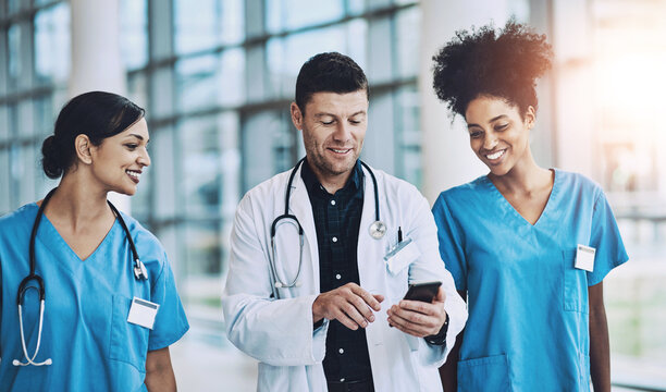 Collaboration, healthcare or phone with doctor and nurses in hospital together for communication. Medical, social media and smile with medicine professional talking to staff in clinic for networking