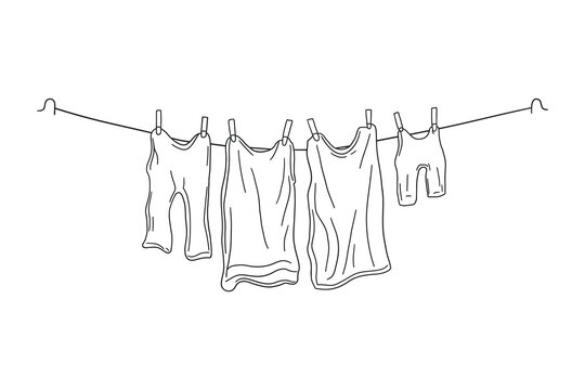 Clothesline with hanging clothes drying on rope in laundry room
