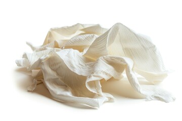 A heap of white fabric lying on a plain white background