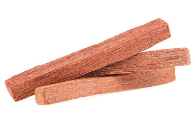 Chandan - group of sandalwood sticks isolated on a white background.