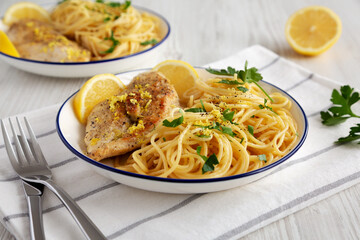 Homemade Lemon Pepper Chicken with Spaghetti Pasta on a Plate, side view.