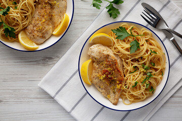 Homemade Lemon Pepper Chicken with Spaghetti Pasta on a Plate, top view.