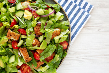 Homemade Crispy Chicken Salad with Tomato and Cucumber on a Plate, top view.