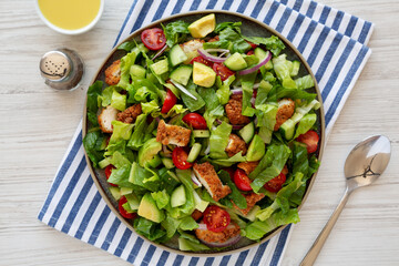 Homemade Crispy Chicken Salad with Tomato and Cucumber on a Plate, top view.