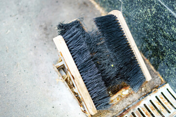 homemade device with three wooden brushes for independent shoe cleaning from all angles simultaneously, promoting convenience and efficiency in footwear care