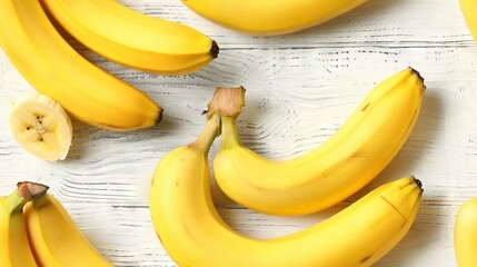   Ripe bananas resting on wooden table, surrounded by chopped ones