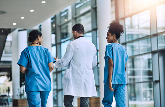 Medical, team and talking to help in hospital, walking and support or collaboration for medicine. Doctor, speaking and consulting on healthcare treatment or diagnosis, nurses and back for solidarity