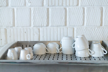 white coffee cups drying on the coffee machine