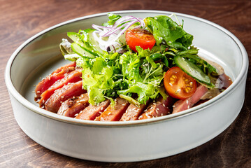 Seared tuna with fresh greens, sesame seeds, and tangy dressing