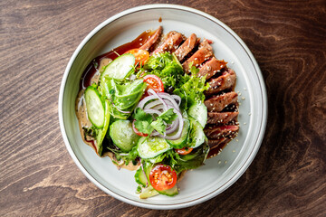 Seared tuna with fresh greens, sesame seeds, and tangy dressing