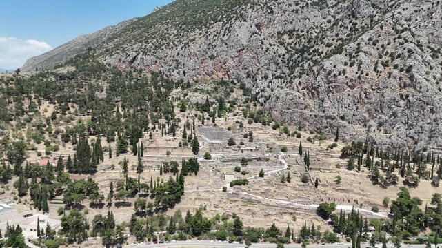 Aerial bird's eye view video taken by drone of archaeological site of ancient Delphi, site of temple of Apollo and the Oracle, Voiotia, Greece