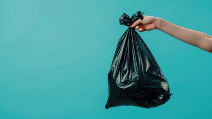 Woman s hand discarding black plastic waste bag on soft colored background with space for text