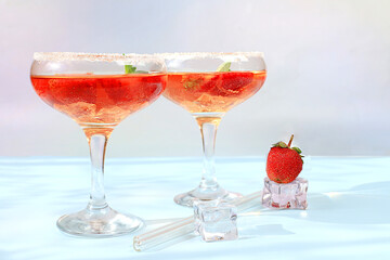 Modern still life with pink martini, alcoholic cocktail, strawberries on elegant modern background, minimal concept for bar and holiday party, cafe, advertising banner, selective focus,