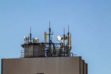 Telecommunication tower with copy space in roof top of building.Digital wireless connection in Brazil