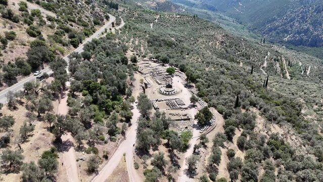 Aerial bird's eye view video taken by drone of archaeological site of ancient Delphi, site of temple of Apollo and the Oracle, Voiotia, Greece