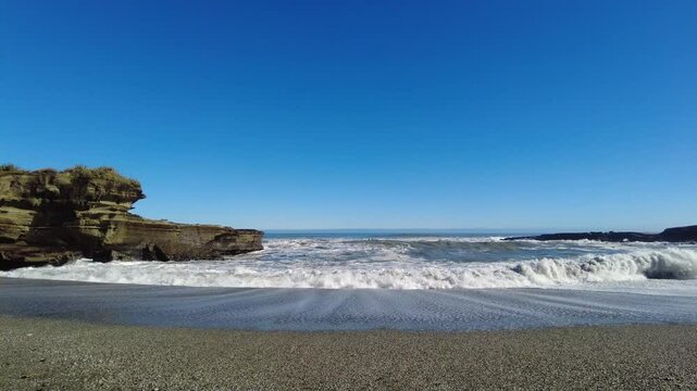 Truman Track in New Zealand, secluded beaches where dramatic cliffs meet the wild Tasman Sea.