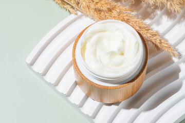 Face cream moisturizer in a bamboo jar, luxury skincare cosmetics and anti-aging product for healthy skin and beauty routine. Top view
