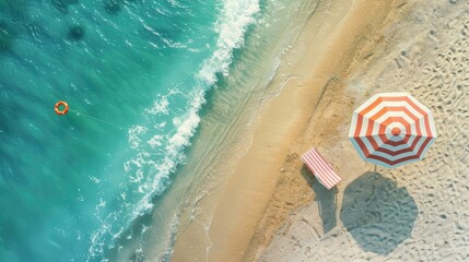 Obraz premium Top view of a beach scene with a striped umbrella, beach chair, and a lifebuoy in the water. Light sand and clear turquoise sea. Summer vacation concept.
