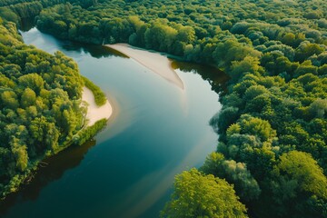 Aerial view of nature with a river flowing through a forest, capturing the beauty of summer. The scenic landscape includes trees, a lake, and a park, perfect for tourism. The drone