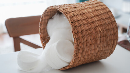 Make-up remover cotton and cotton balls in a wicker basket on background