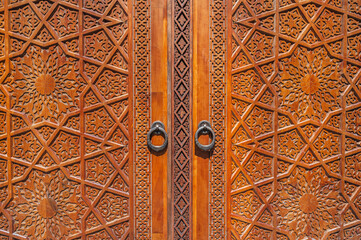 traditional Arabic Uzbek Islamic patterns arabesque ornament on an ancient wooden carved door in Uzbekistan