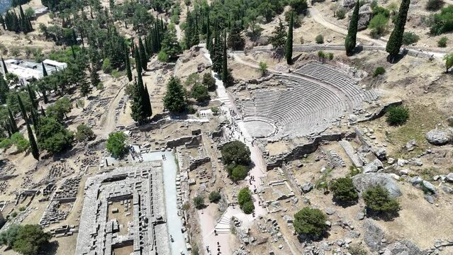 Aerial bird's eye view video taken by drone of archaeological site of ancient Delphi, site of temple of Apollo and the Oracle, Voiotia, Greece