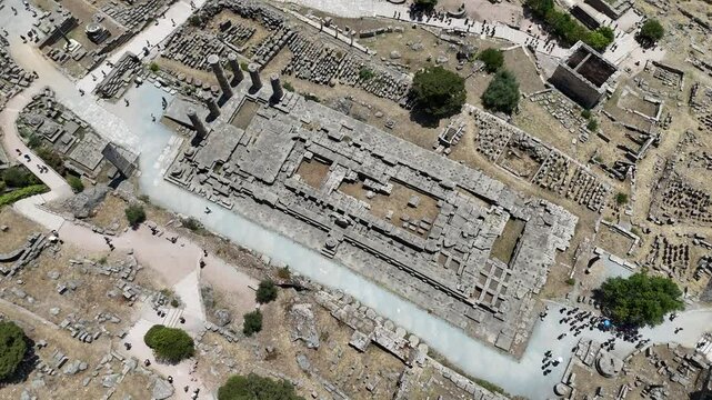 Aerial bird's eye view video taken by drone of archaeological site of ancient Delphi, site of temple of Apollo and the Oracle, Voiotia, Greece