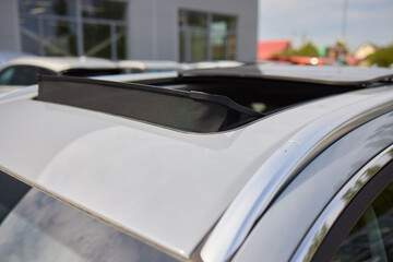 Motor vehicle with sunroof, rear view mirror, and hood