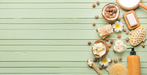 Coconut shell with shea butter, nuts and bath supplies on color wooden background