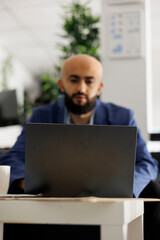 Arab startup business entrepreneur working at market research on laptop. Company professional employee planning project development and typing on computer in modern office