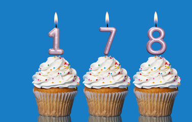 Birthday Cupcakes With Candles Lit Forming The Number 178