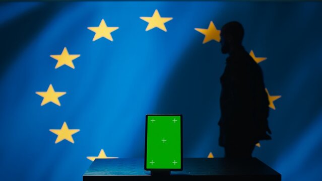 European Union counterintelligence division uses green screen tablet to protect against propaganda affecting elections. EU security service safeguarding democracy online using mockup device, camera B